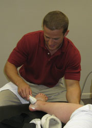 Chiropractic Intern Tony Lawther treating ankle sprain injury